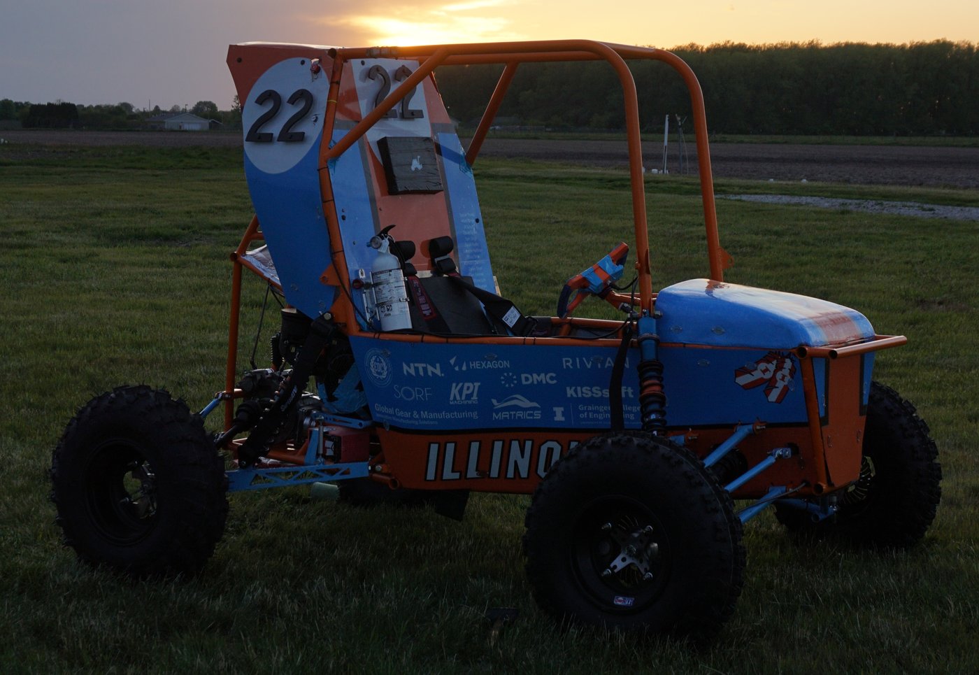 Natilee, the Off-Road Illini Baja car, parked in a field at sunset